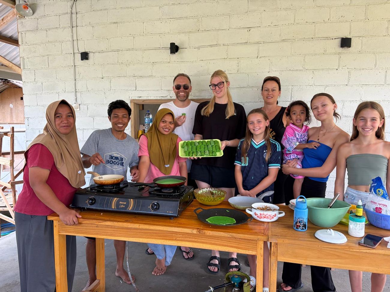 Guests and the family after the cooking class