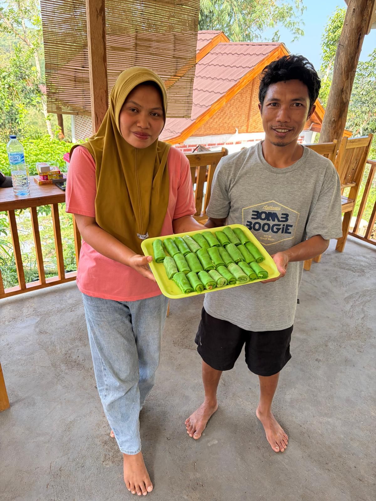 Sumaedi and his wife with a tray of pandan pancakes
